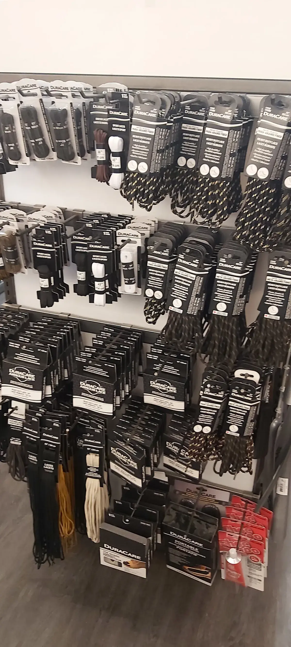 A pegged wall of belts, buckles and lanyards