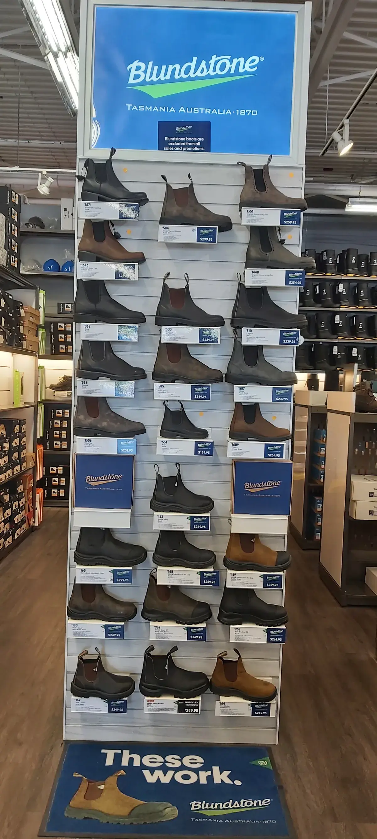 A Blundstone display tower stocked with Chelsea boots, from the aisle