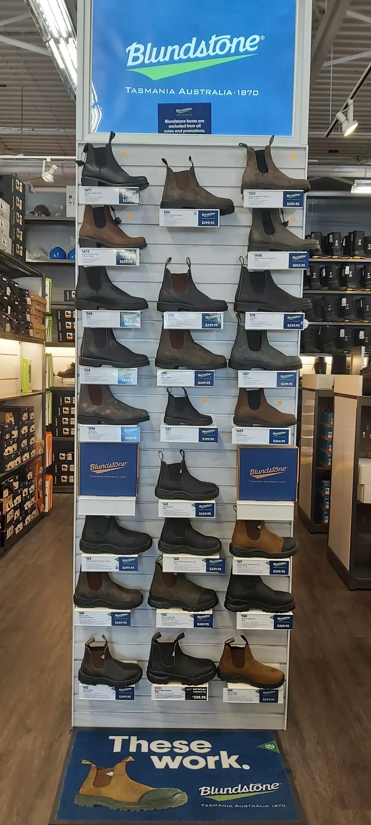 A Blundstone display tower with boots on every shelf, under a Blundstone Tasmania Australia sign