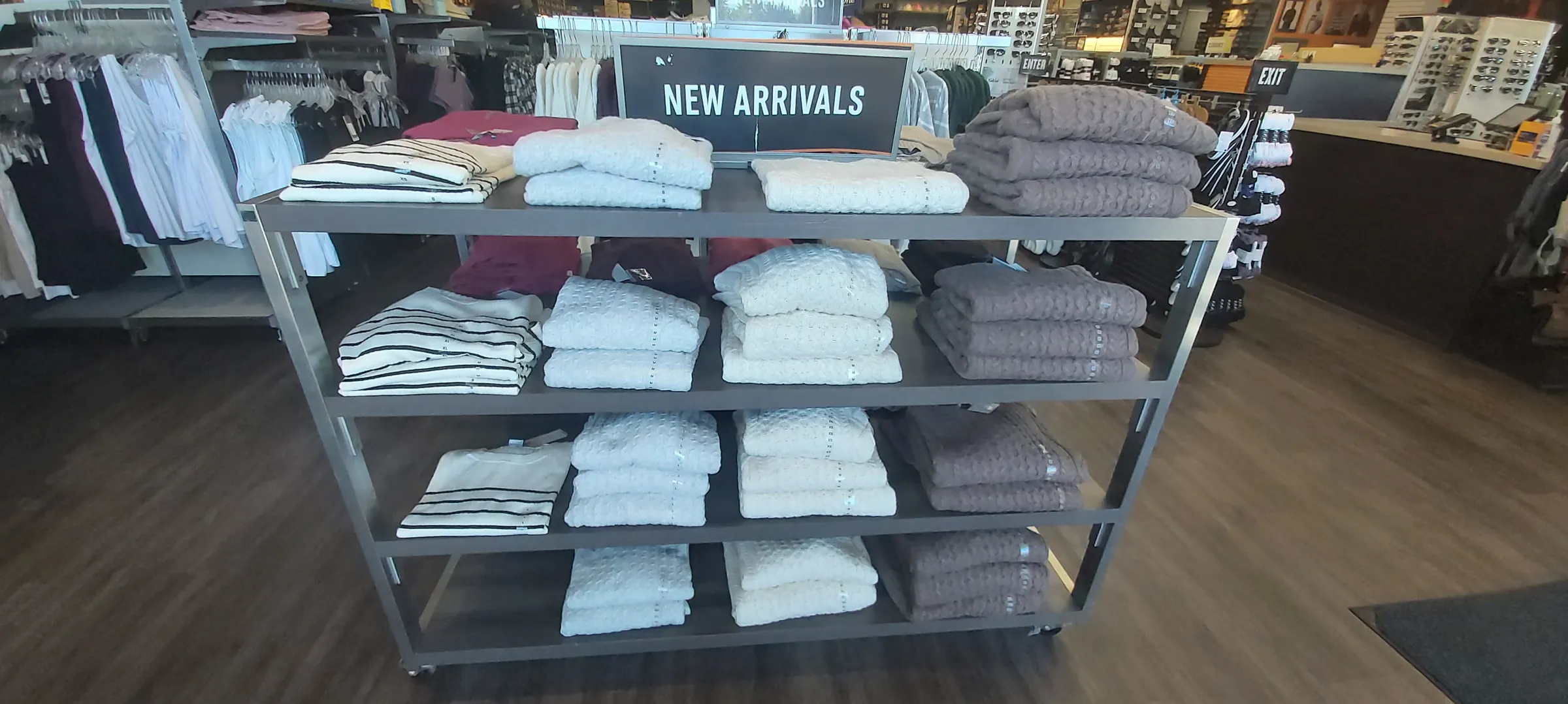 A New Arrivals table with folded tops in white, grey and cream