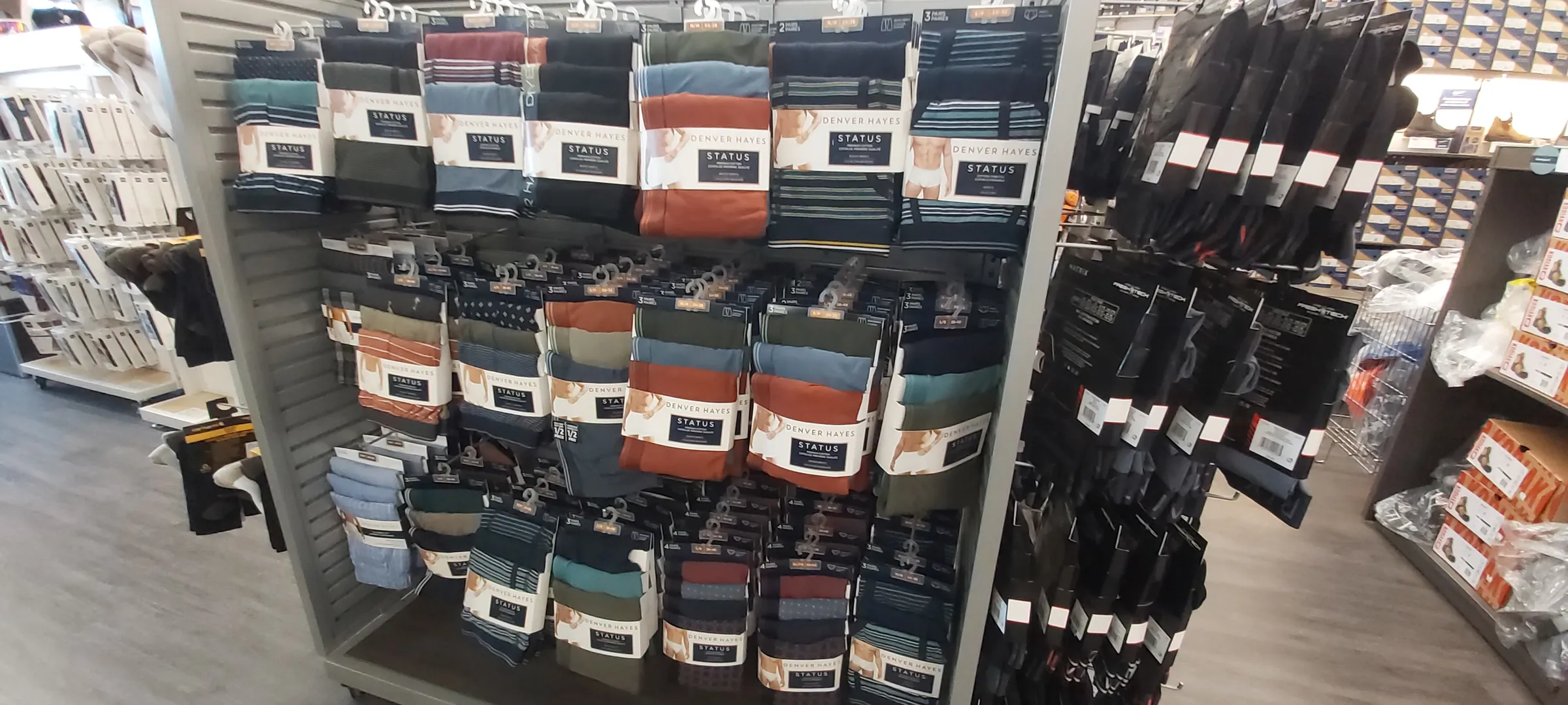 A wall of packaged socks and underwear on pegs beside hung basics